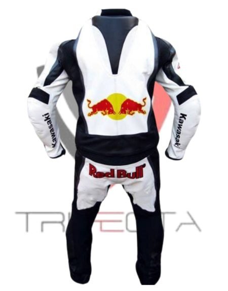 A professional motorcycle racing suit predominantly white with black and blue accents, featuring the Red Bull logo on the chest and shoulders, and the Kawasaki logo on the lower abdomen. The suit has ‘Ninja’ written across the upper back and includes protective patches on the shoulders, elbows, and knees. The attached boots are black with white accents, and the suit has an aerodynamic hump on the upper back